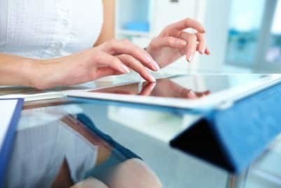 Close-up of a female touching the screen of a tablet computer