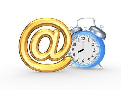 Email sign beside a clock