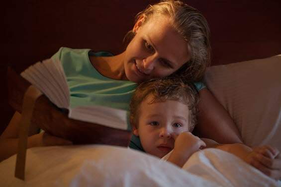 Mum reading bedtime story to child